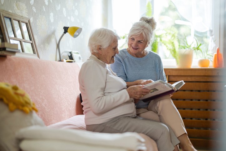 Daughter visiting her mother in a memory care facility chosen with help from a senior living advisor