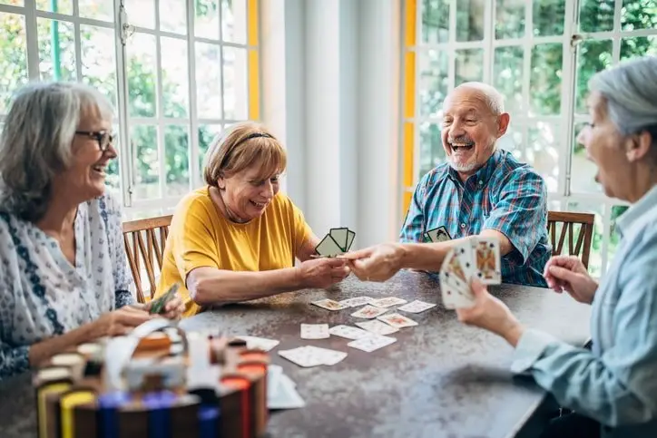 seniors playing card games in an independent living facility that a senior living advisor helped find